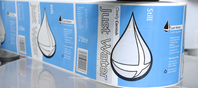 Image of labels being applied to bottles