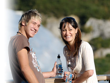 Couple drinking water from bottles
