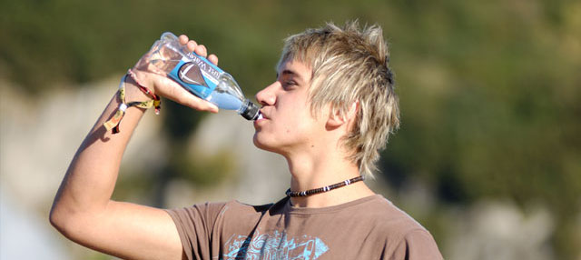Young man drinking water from bottle