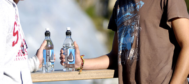 Woman and man holding bottled water